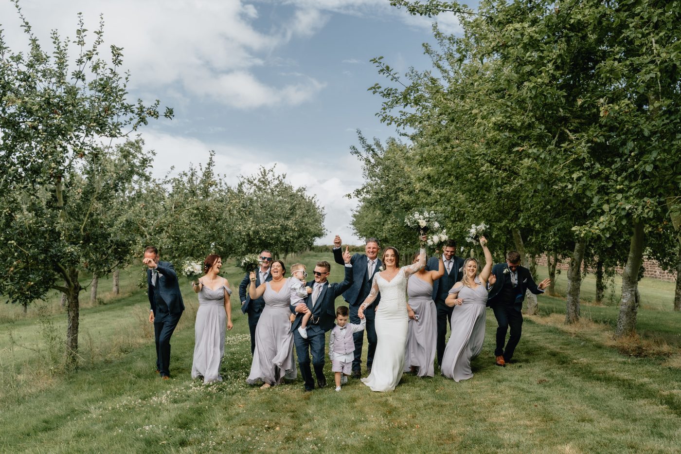 Wedding party in the Orchard, wedding tipis, tipi wedding venues, outdoor wedding venues near me, apple orchard wedding, relaxed wedding venues