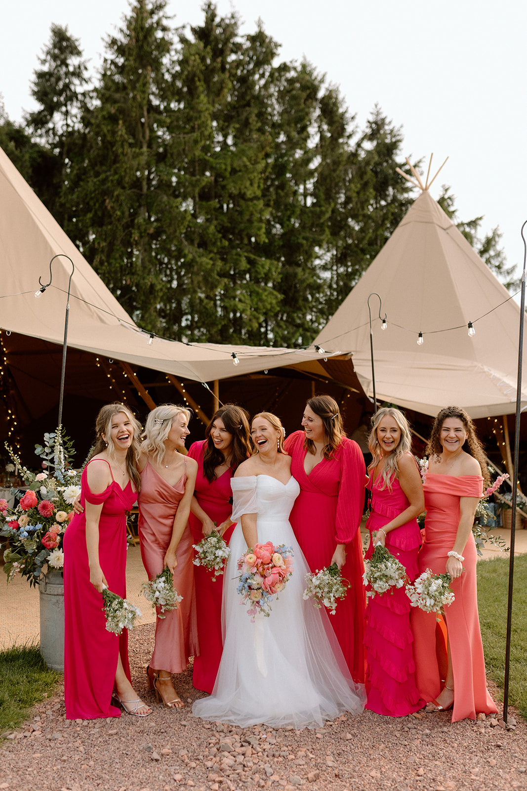 bride and bridesmaids outside tipis